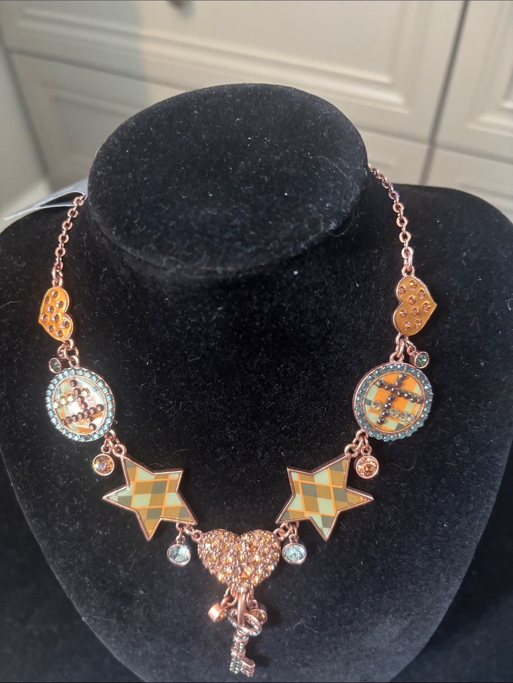 Pilgrim Danish Design copper tone necklace with stars, hearts and medallions.